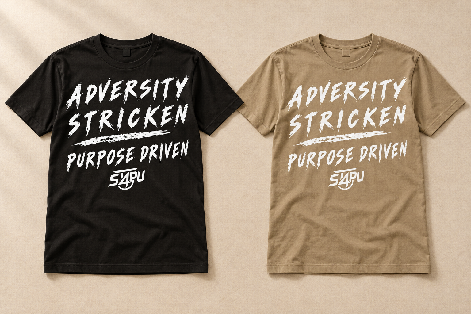 A black and a tan Stricken 4 Purpose tee laid side by side, both printed with Adversity Stricken, Purpose Driven